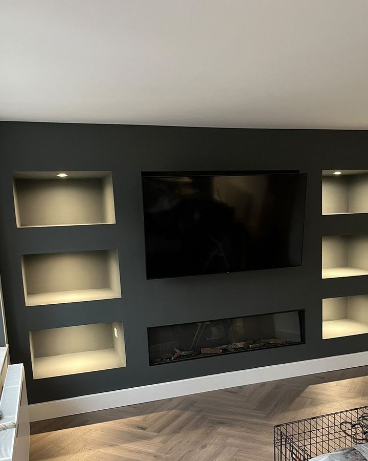 Charcoal media wall, lit alcoves and herringbone flooring